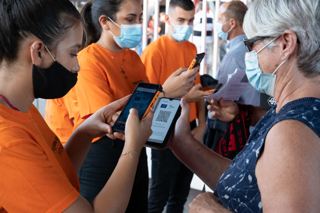 Une rangée d'employés d'accueil vérifient les pass sanitaires de membres du public. Après une année de matches à huis-clos en raison de la crise sanitaire, le public a pu de nouveau se rendre au stade Ernest Wallon à l’occasion du match de clôture de la 2e journée du Top 14. Champion de France en titre, le Stade Toulousain recevait le Rugby Club Toulonnais. Le match s'est joué à guichets fermés et près de 19000 contrôles de pass sanitaires ont été effectués à l'entrée du stade. Le Stade Toulousain l’a remporté par 41 à 10. Toulouse, stade Ernest Wallon, le 12 septembre 2021.